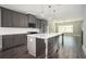 Modern kitchen with gray cabinets, stainless steel appliances, a large island with pendant lighting, and an open floorplan at 1947 Drew Nw Dr, Atlanta, GA 30318