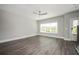 Open living room features wood-look flooring, neutral paint, large windows, and a ceiling fan at 1947 Drew Nw Dr, Atlanta, GA 30318