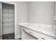 Walk-in pantry with white cabinets, quartz countertops, and wire shelving provides ample storage at 1947 Drew Nw Dr, Atlanta, GA 30318