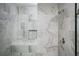 Shower featuring marble tile, custom shelf, seat, brushed nickel fixtures at 1947 Drew Nw Dr, Atlanta, GA 30318