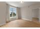 Bedroom featuring wood floors, neutral walls, a window with curtains, and white trim at 285 Centennial Olympic Park Nw Dr # 809, Atlanta, GA 30313