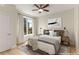 Staged bedroom featuring a ceiling fan, a plush bed, neutral walls, and a large window with a cityscape view at 285 Centennial Olympic Park Nw Dr # 809, Atlanta, GA 30313