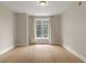 The bedroom with hardwood floors, base molding, neutral walls and a window offering city views at 285 Centennial Olympic Park Nw Dr # 809, Atlanta, GA 30313