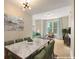 Dining room boasts a marble table, ample seating, and flows into a staged living area at 285 Centennial Olympic Park Nw Dr # 809, Atlanta, GA 30313