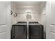 This laundry room features a modern washer and dryer, with storage shelves on the wall at 285 Centennial Olympic Park Nw Dr # 809, Atlanta, GA 30313