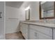 Bathroom with double sink vanity, granite countertops, and framed mirrors at 6851 Roswell Rd # G20, Sandy Springs, GA 30328
