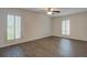 Bright bedroom with ceiling fan and two shuttered windows at 6851 Roswell Rd # G20, Sandy Springs, GA 30328
