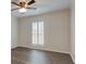 Bedroom with wood-look vinyl floors, large window, and ceiling fan at 6851 Roswell Rd # G20, Sandy Springs, GA 30328