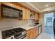 Modern kitchen with stainless steel appliances including gas stove, microwave, and sink with dishwasher at 6851 Roswell Rd # G20, Sandy Springs, GA 30328