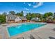 Community swimming pool with lounge chairs and umbrellas and mature trees at 6851 Roswell Rd # G20, Sandy Springs, GA 30328
