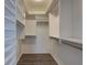 Spacious walk-in closet with custom shelving and hanging rods for optimal organization and storage solutions at 6851 Roswell Rd # G20, Sandy Springs, GA 30328