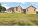 Expansive backyard view of a house with a large lawn, patio, and deck at 739 E Mays E Rd, Stockbridge, GA 30281