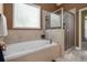 Bright bathroom with soaking tub, large window and glass enclosed shower at 739 E Mays E Rd, Stockbridge, GA 30281
