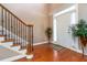 Elegant foyer with hardwood floors, staircase, and natural light streaming in from the front door at 739 E Mays E Rd, Stockbridge, GA 30281