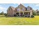 Beautiful front exterior of home showcasing a manicured lawn and a covered porch at 739 E Mays E Rd, Stockbridge, GA 30281