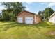 View of a large detached garage with two doors and a grassy yard at 739 E Mays E Rd, Stockbridge, GA 30281