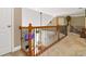 Carpeted hallway featuring wooden railings and staircase access to other rooms at 739 E Mays E Rd, Stockbridge, GA 30281