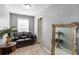 Small sitting area with a black leather sofa, decorative mirror and house plant at 739 E Mays E Rd, Stockbridge, GA 30281