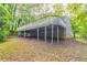 The backyard has a large deck raised on supports with steps leading down to a muddy area at 740 Stoneside Ct, Stone Mountain, GA 30083
