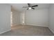 Large carpeted bedroom featuring neutral color scheme, ceiling fan, and closet at 740 Stoneside Ct, Stone Mountain, GA 30083