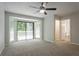 Carpeted bedroom with bay window, ceiling fan, and ensuite bath at 740 Stoneside Ct, Stone Mountain, GA 30083