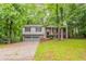 Charming split-level home featuring a two-car garage and lush green landscaping at 740 Stoneside Ct, Stone Mountain, GA 30083