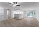 Spacious living room flows into the kitchen, with hardwood floors, and sliding glass doors at 740 Stoneside Ct, Stone Mountain, GA 30083