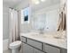 Bright bathroom showcasing a modern vanity, toilet, and shower combination at 1399 Flathead River Ln, Marietta, GA 30064