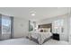 Bright bedroom with large windows, plush carpeting, and an elegant upholstered headboard at 1399 Flathead River Ln, Marietta, GA 30064