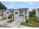 Attractive townhome showcasing a well-kept lawn, a two-car garage, and a welcoming entrance at 1399 Flathead River Ln, Marietta, GA 30064