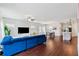 Spacious living room with wood floors, blue sofa, and open layout to the kitchen and dining area at 1399 Flathead River Ln, Marietta, GA 30064
