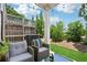 Cozy patio with stylish furniture, complemented by lush greenery and a wooden fence at 1399 Flathead River Ln, Marietta, GA 30064