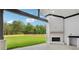 Spacious backyard includes a covered patio with an outdoor fireplace and a lush lawn at 3061 Bold Springs Rd, Dacula, GA 30019