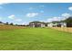 Expansive backyard with lush green grass, a wooden fence, and a view of the home's rear exterior at 3061 Bold Springs Rd, Dacula, GA 30019