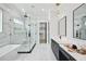 Elegant bathroom boasts a freestanding tub, glass shower, double vanity, and marble tile flooring at 3061 Bold Springs Rd, Dacula, GA 30019