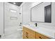Bathroom features marble tile in the shower over tub, black hardware, and light wood cabinet at 3061 Bold Springs Rd, Dacula, GA 30019