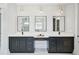Bathroom with double sinks, black cabinets, granite countertops and statement mirrors at 3061 Bold Springs Rd, Dacula, GA 30019