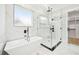 Modern bathroom featuring a freestanding tub, glass shower, and sleek fixtures at 3061 Bold Springs Rd, Dacula, GA 30019
