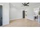 Bright bedroom boasts light hardwood floors, a ceiling fan, and access to the en suite bathroom at 3061 Bold Springs Rd, Dacula, GA 30019