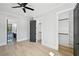Bedroom with ceiling fan, hardwood floors, walk in closets and view to the bathroom at 3061 Bold Springs Rd, Dacula, GA 30019