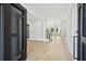 Bright foyer featuring light hardwood floors, staircase and a modern black door at 3061 Bold Springs Rd, Dacula, GA 30019
