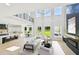 Bright, open-concept living room with a soaring ceiling and gourmet kitchen in the background at 3061 Bold Springs Rd, Dacula, GA 30019