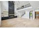 Open living space featuring a fireplace, staircase, hardwood floors, and abundant natural light at 3061 Bold Springs Rd, Dacula, GA 30019