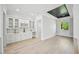 Bright room with light wood floors, recessed lighting, built-in cabinets, and a beverage area at 3061 Bold Springs Rd, Dacula, GA 30019
