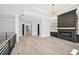 Spacious living area features hardwood flooring, fireplace, modern light fixture, and lots of natural light at 3061 Bold Springs Rd, Dacula, GA 30019