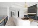 Open living area features hardwood flooring, fireplace, modern light fixture, and lots of natural light at 3061 Bold Springs Rd, Dacula, GA 30019