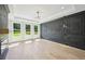Bright primary bedroom with a decorative wall, light wood floors, and an abundance of natural light at 3061 Bold Springs Rd, Dacula, GA 30019