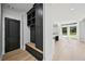 Inviting mudroom features built-in storage, a bench, and a door leading to the interior and a view of an open-concept interior at 3061 Bold Springs Rd, Dacula, GA 30019