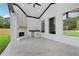 Covered patio features a sleek fireplace and outdoor counter, ideal for relaxation and entertaining at 3061 Bold Springs Rd, Dacula, GA 30019
