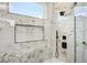 Close up of shower with luxury marble tile, and window for natural light at 3061 Bold Springs Rd, Dacula, GA 30019